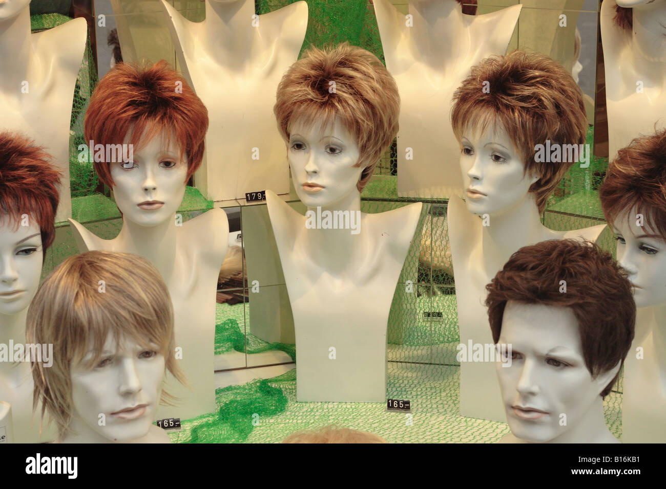 Wig shop window display hair pieces for women and men Stock Photo - Alamy
