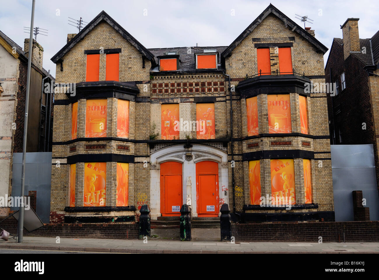Housing on Edge Lane in Liverpool boarded up with colorful artwork in
