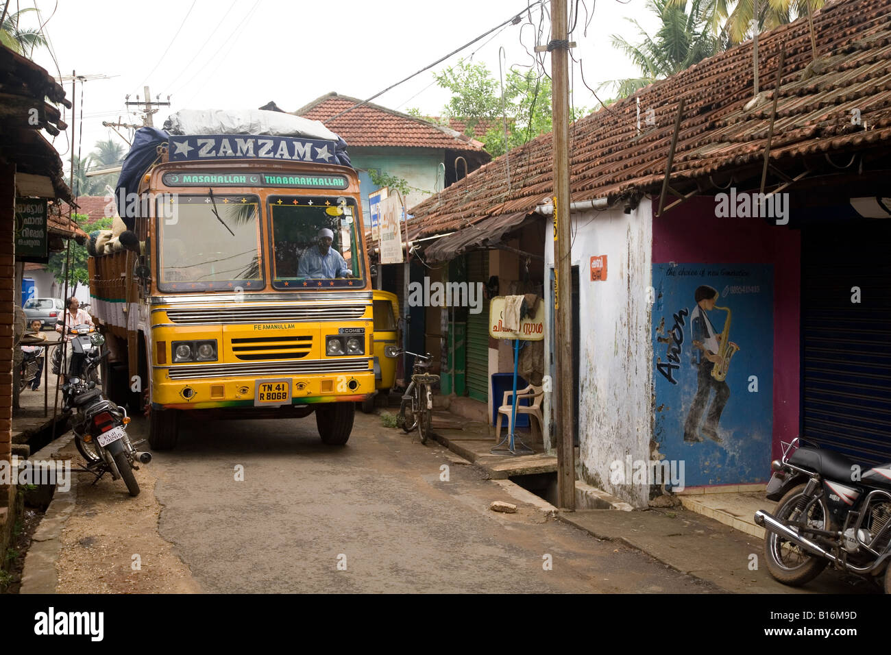 A big lorry on a narrow street. A heavy goods vehicle attempts to get through a narrow lane. Stock Photo