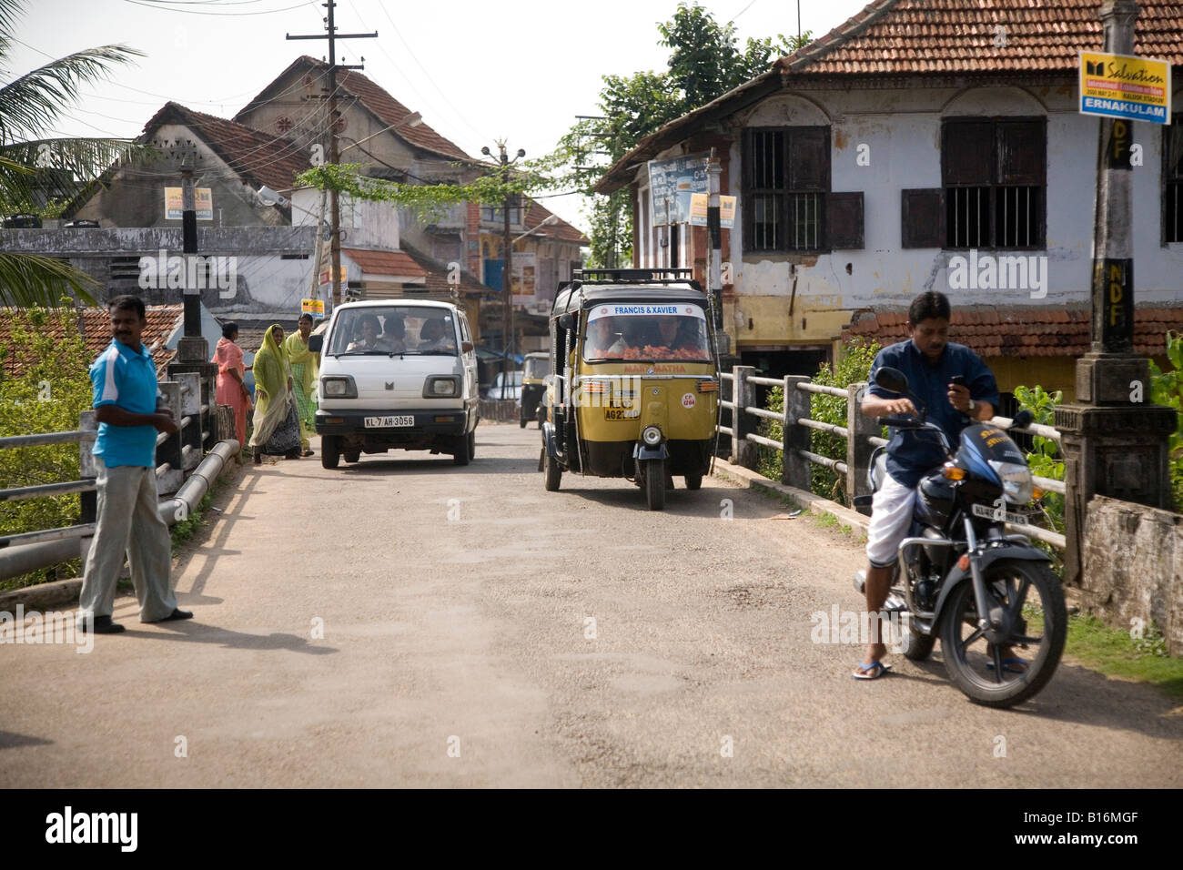 The road between Fort Kochi and Mattancherry in Kochi, India. Pedestrians and motorised transport use the bridge. Stock Photo