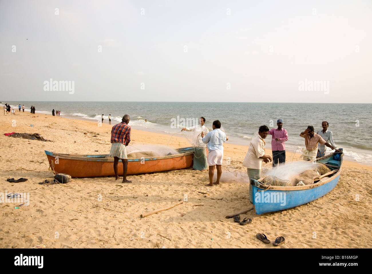 Fishermen and fishing boats on Ullal beach at Managlore, Karnataka. The