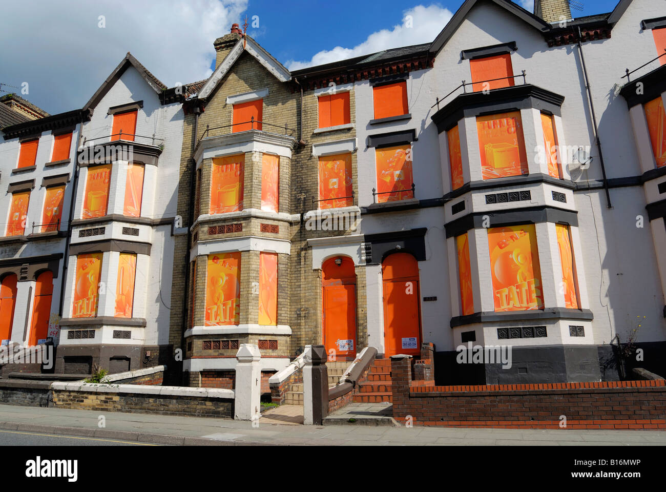 Housing on Edge Lane in Liverpool boarded up with colorful artwork in