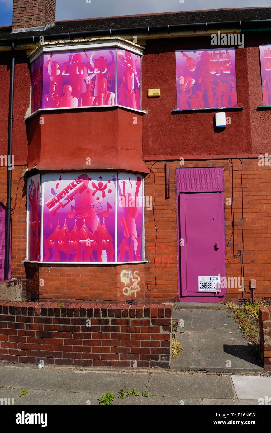Housing on Edge Lane in Liverpool boarded up with colorful artwork in