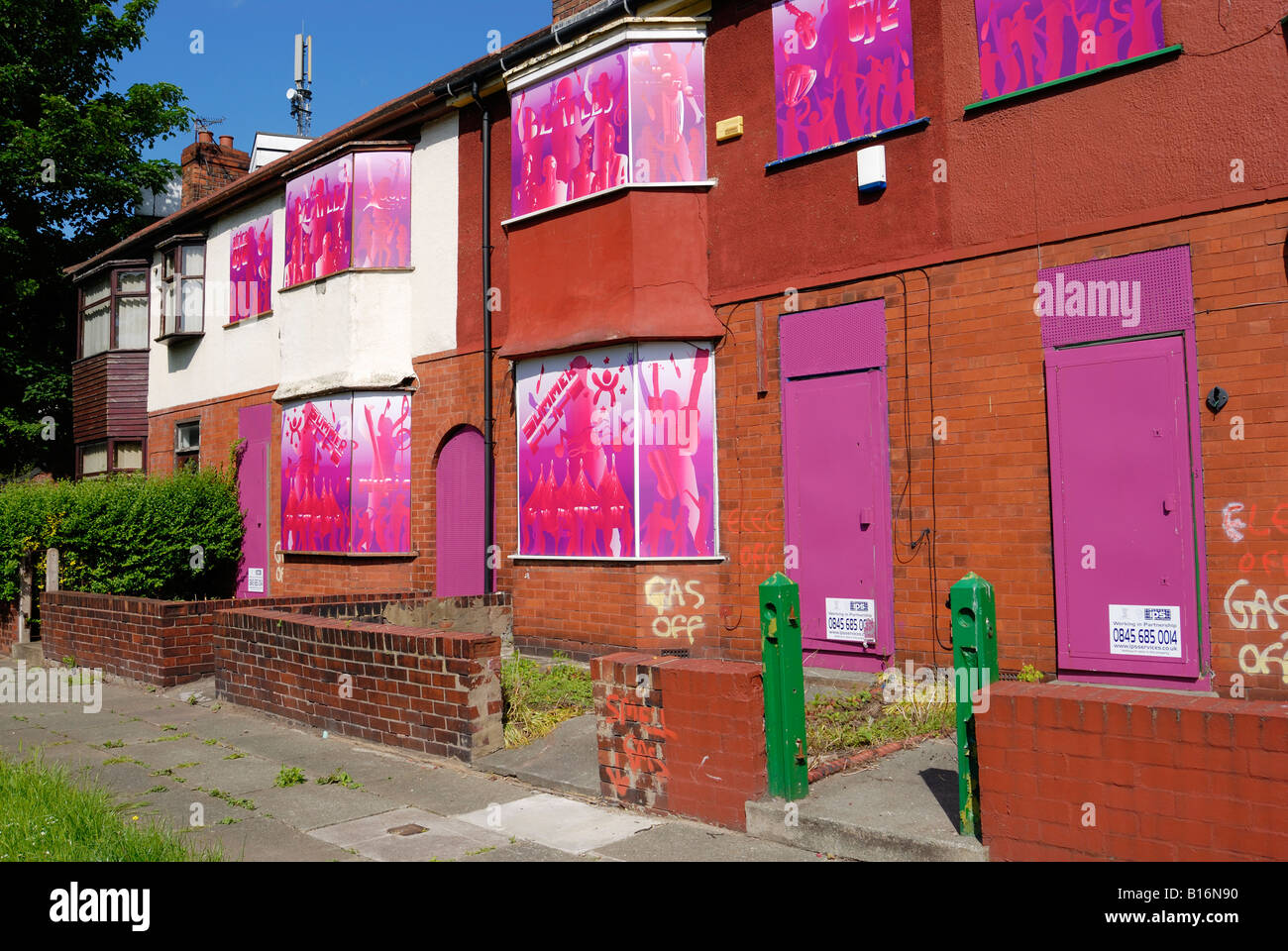Housing on Edge Lane in Liverpool boarded up with colorful artwork in