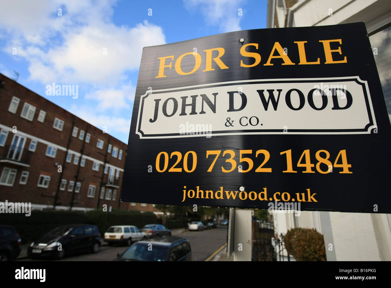 A For Sale sign is posted outside a house in Chelsea central London Stock Photo