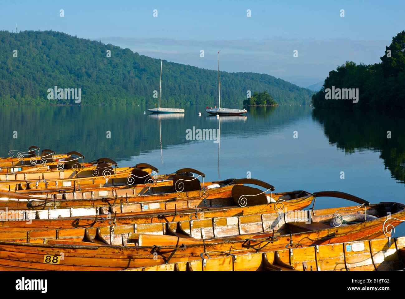 Rowing boats for hire, tied up to pier at Bowness Bay, Lake Windermere, Lake District National Park, Cumbria, England UK Stock Photo
