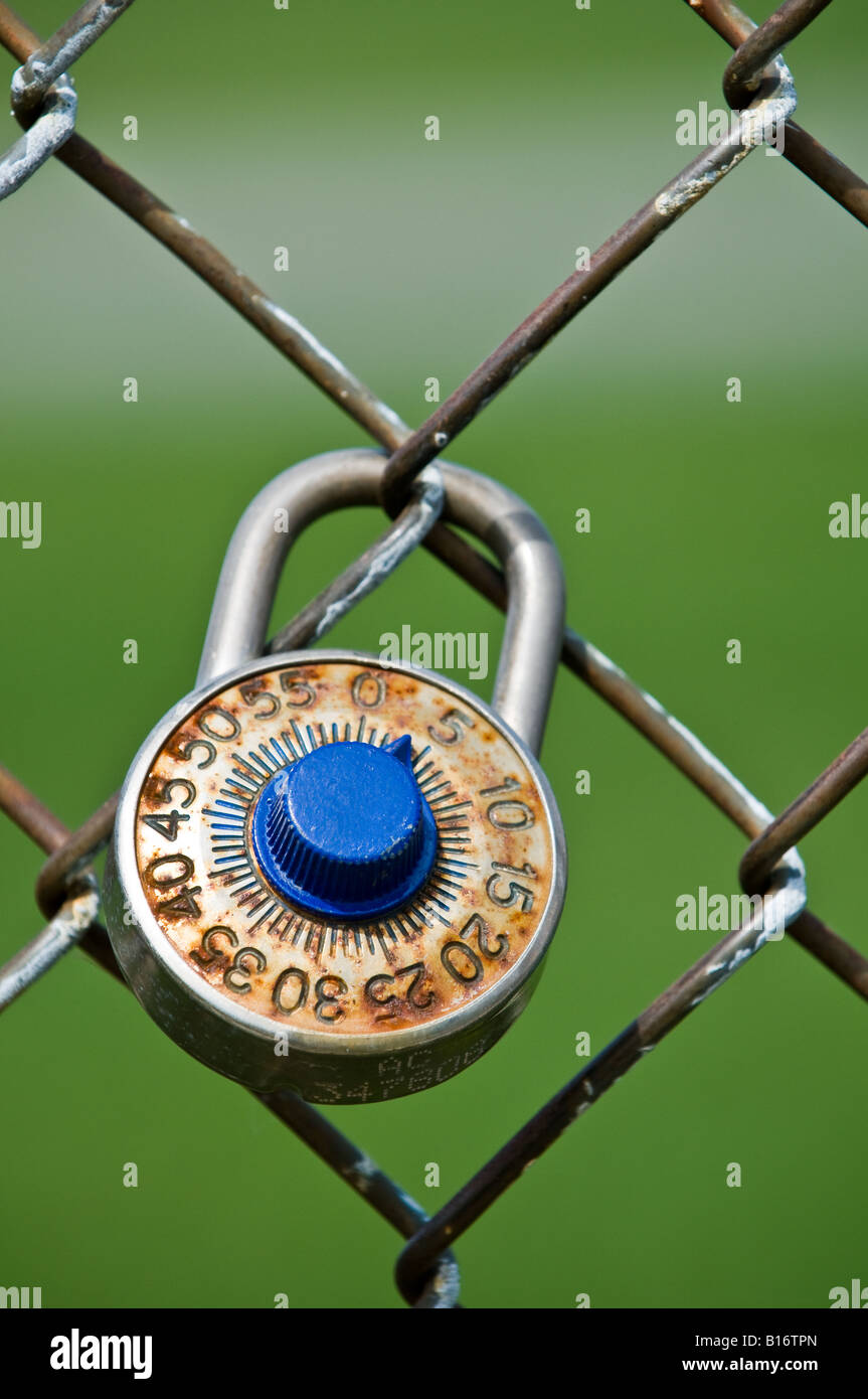 A combination lock secured around a chain link fence Stock Photo Alamy
