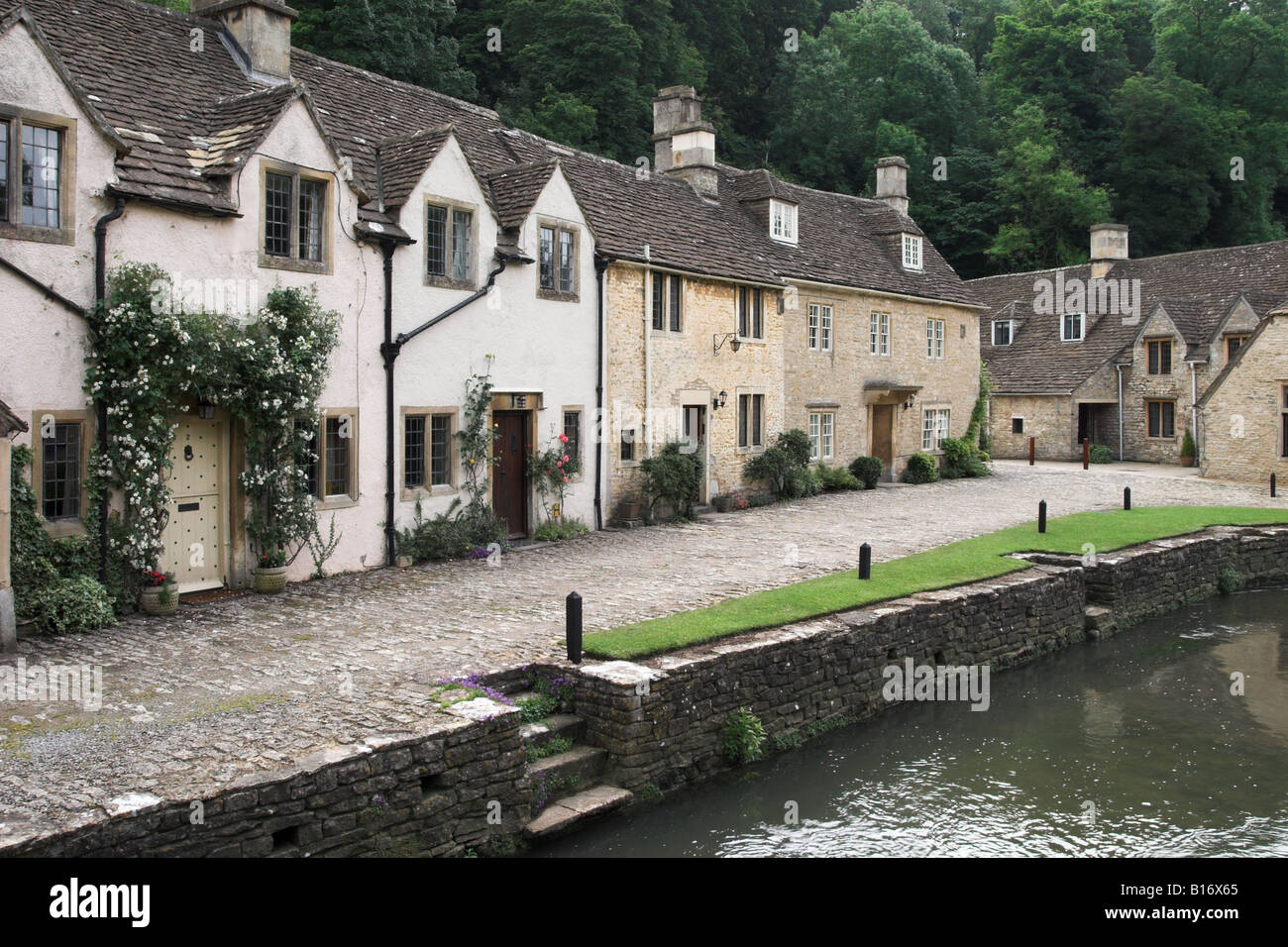 Picturesque cottages overlooking By Brook, the river which runs through Castle Combe, The Cotswolds, Wiltshire, England, UK Stock Photo