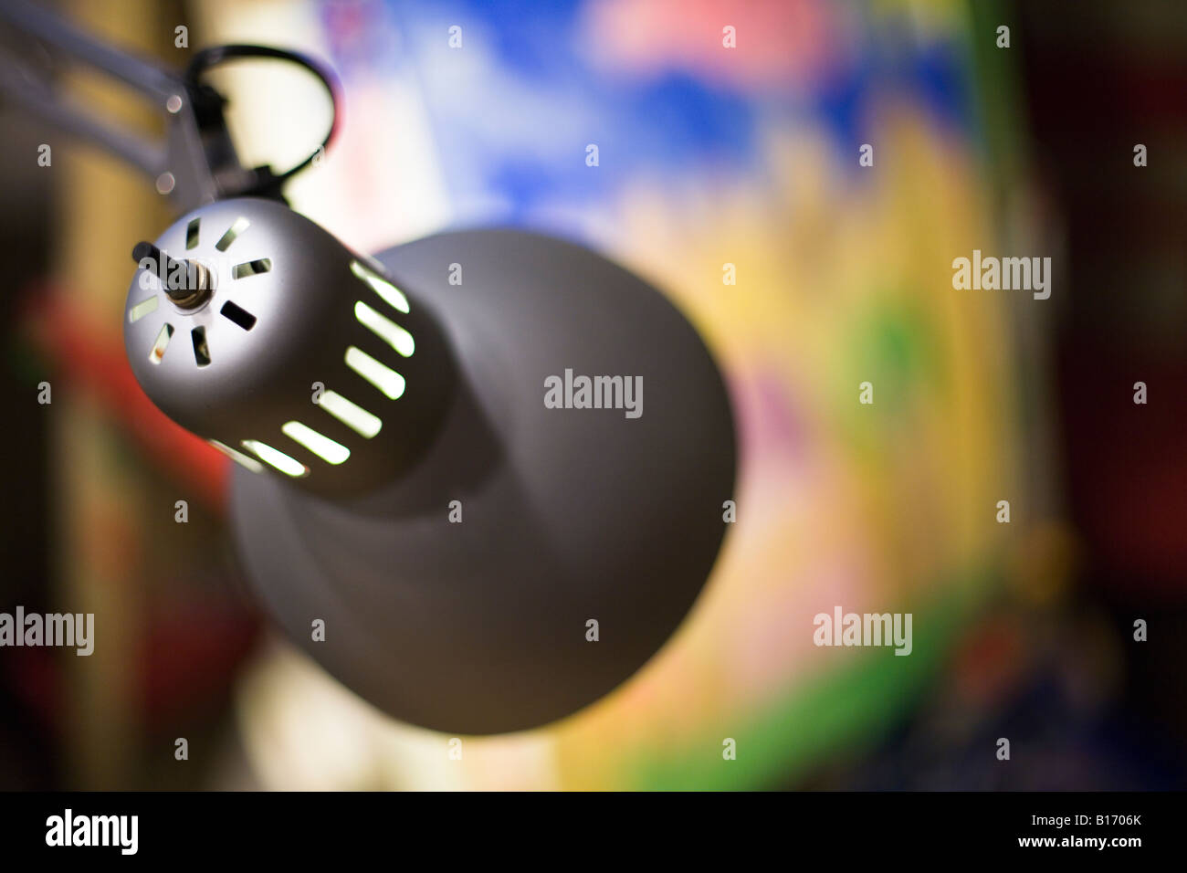 desk lamp lighting a painting Stock Photo