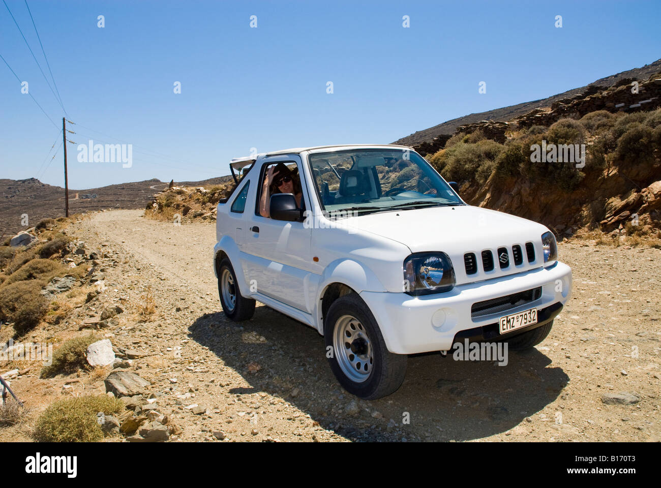 On the road in a Suzuki Jimny 4x4 car Lichnaftia Tinos Greece Stock Photo -  Alamy
