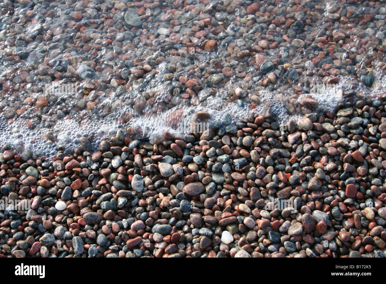 Beach pebbles and wave, Lake Superior Stock Photo