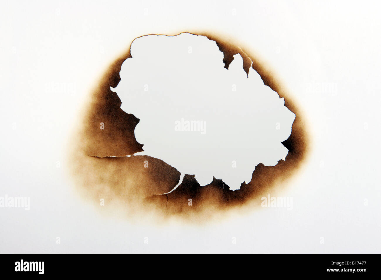 Burn hole in a piece of paper Stock Photo - Alamy