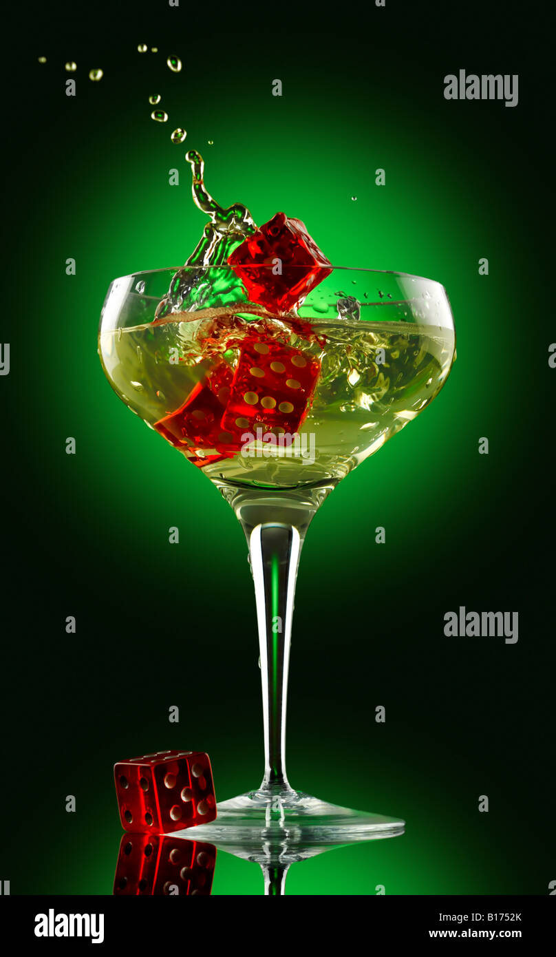 champagne glass and dice over green background Stock Photo