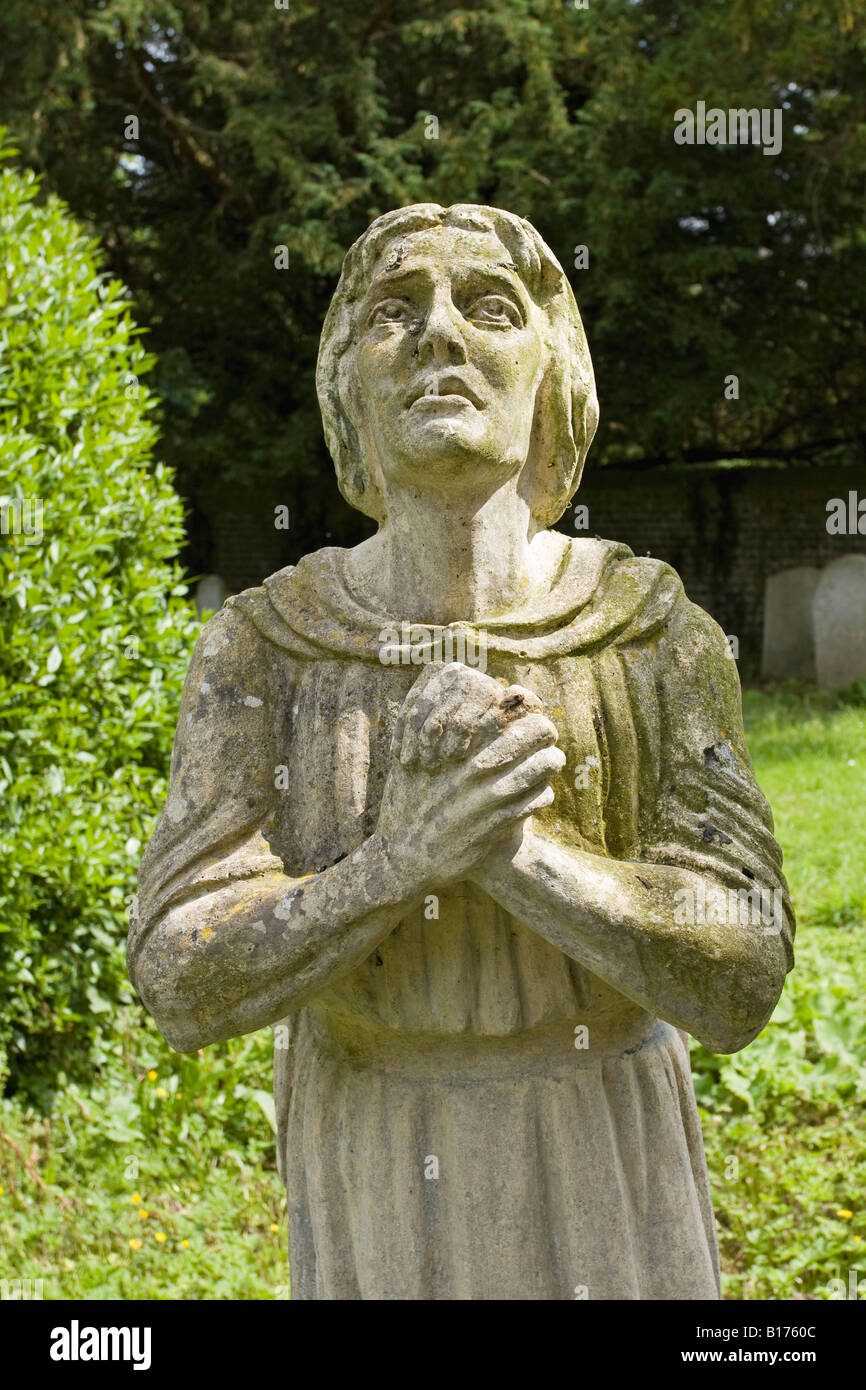 Life size stone figure in English churchyard Stock Photo