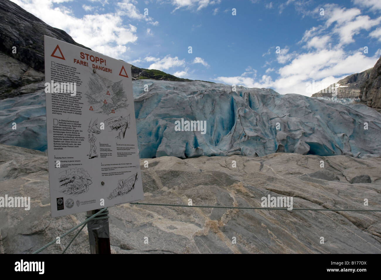 Warning sign at the edge of Nigardsbreen glacier in Nigard, Jostdalen, Norway Stock Photo