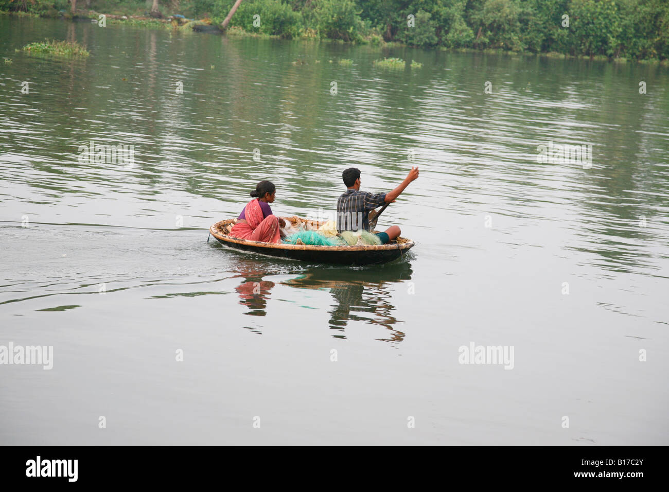 Wife and husband sailing a small country boat in kochi, kerala,india