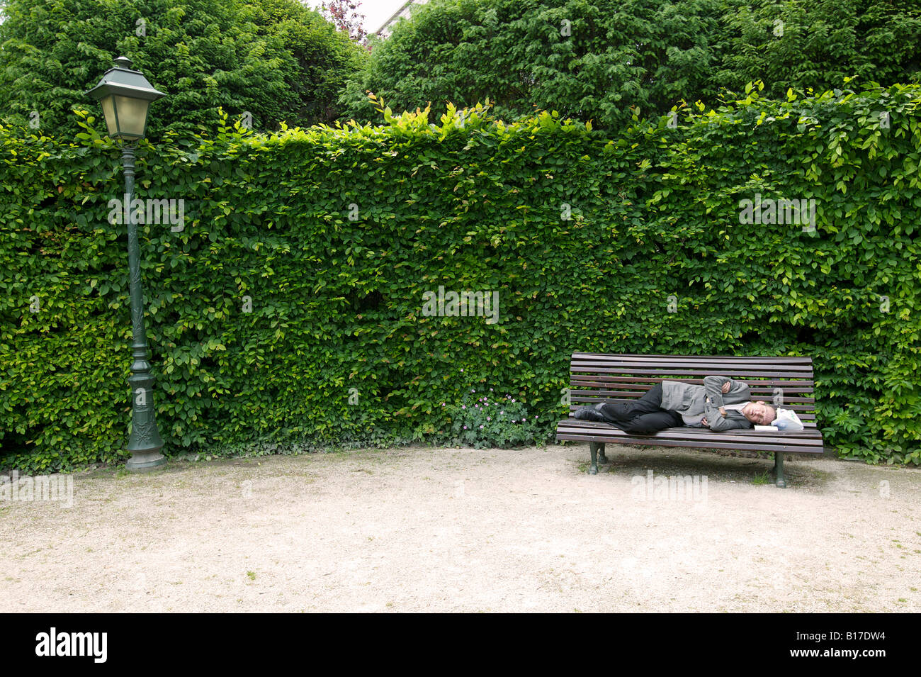 Man sleeping on a bench Stock Photo - Alamy