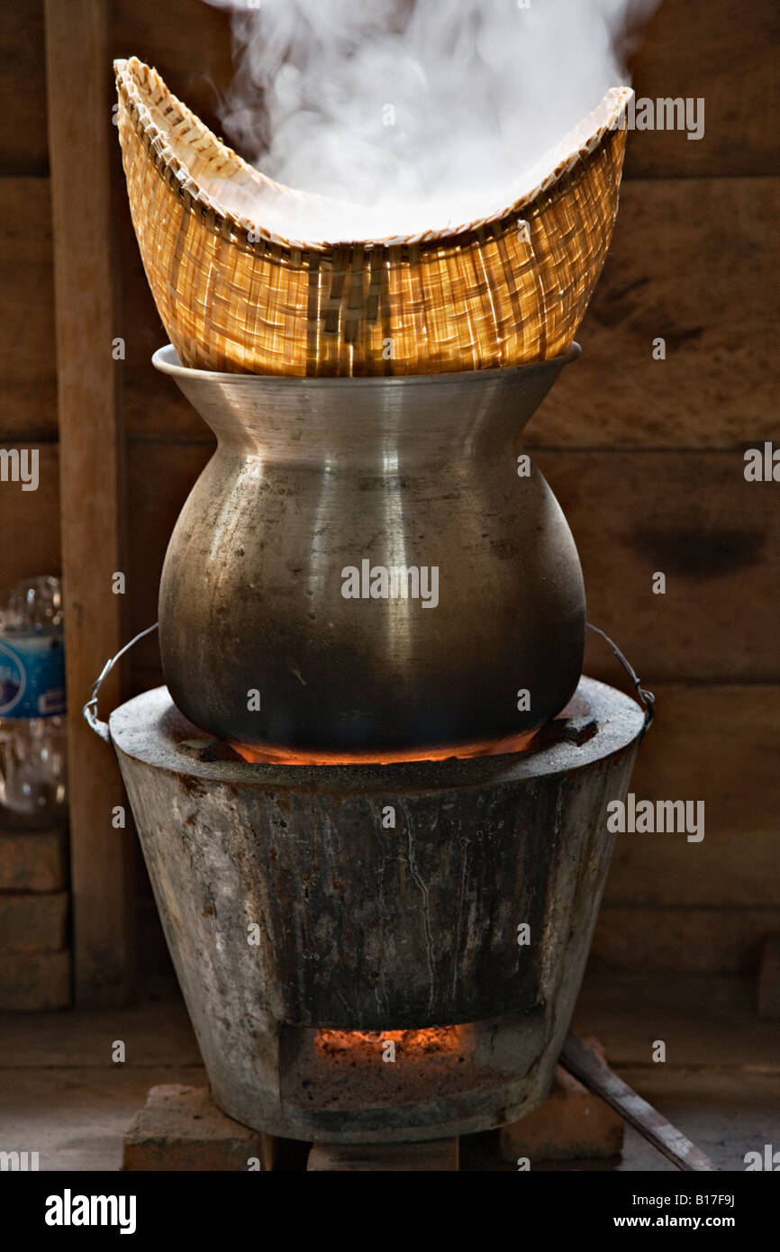Sticky rice steaming in basket over charcoalfired steamer, Don Daeng