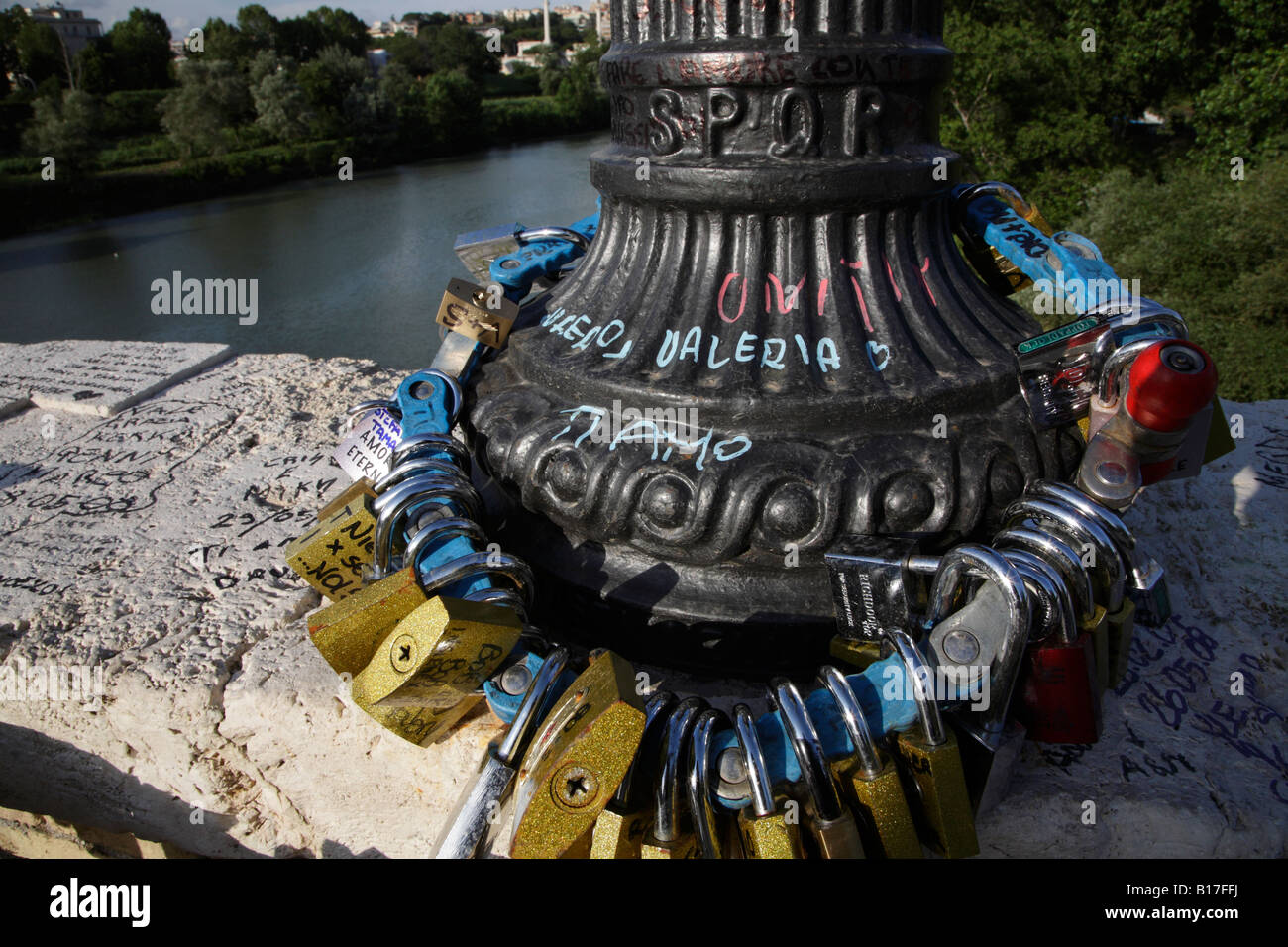 padlocks strung round lamppost on Ponte Milvio in Rome professing young