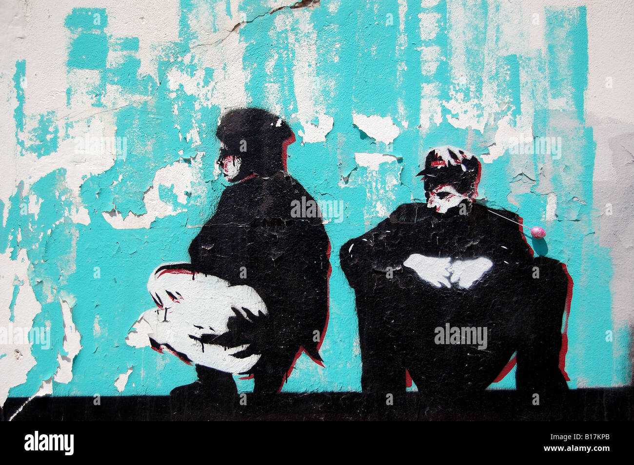 Stencil graffiti against an old weathered wall with peeling paint. Urban street art background. Stock Photo