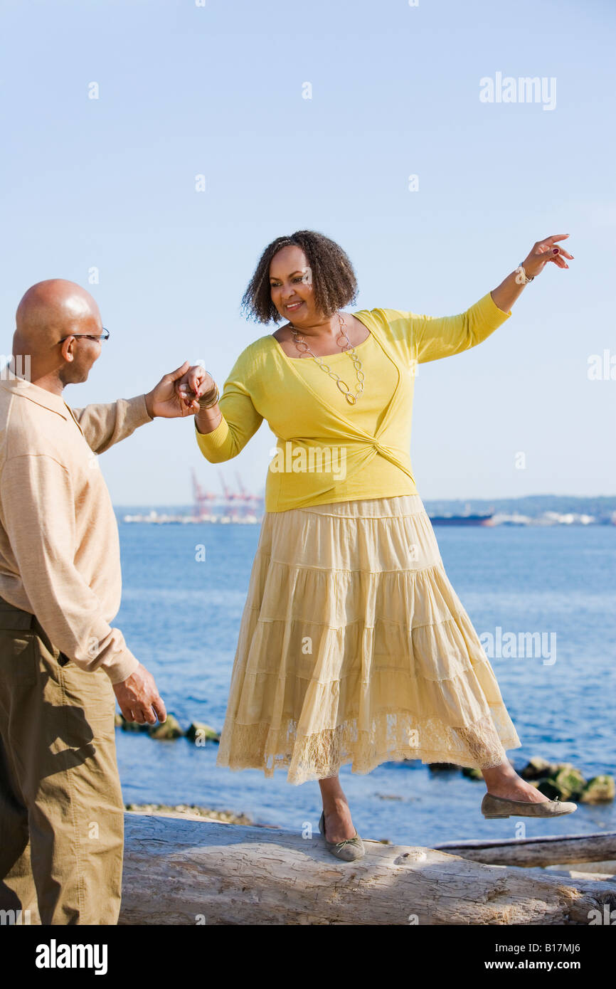 African American woman holding husband’s hand for balance Stock Photo
