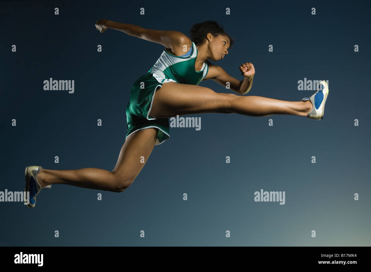 African American female athlete jumping Stock Photo