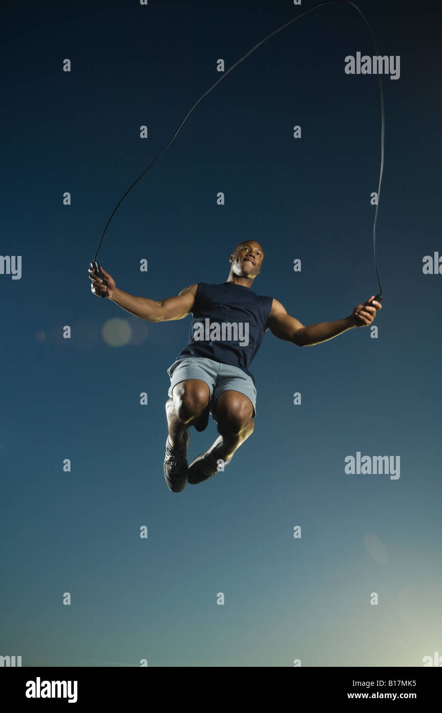 African American man jumping rope Stock Photo
