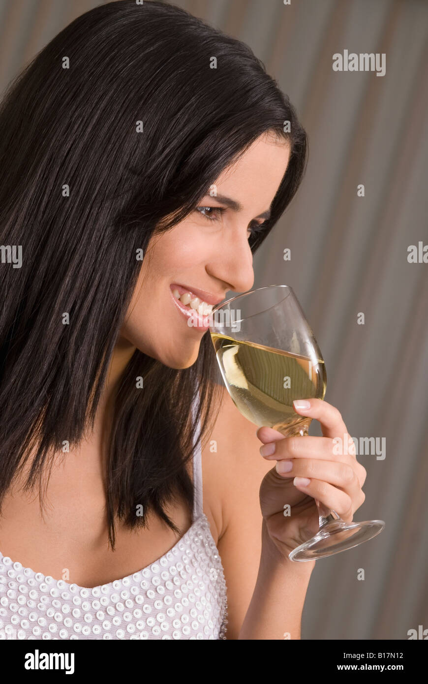 Hispanic woman drinking wine Stock Photo