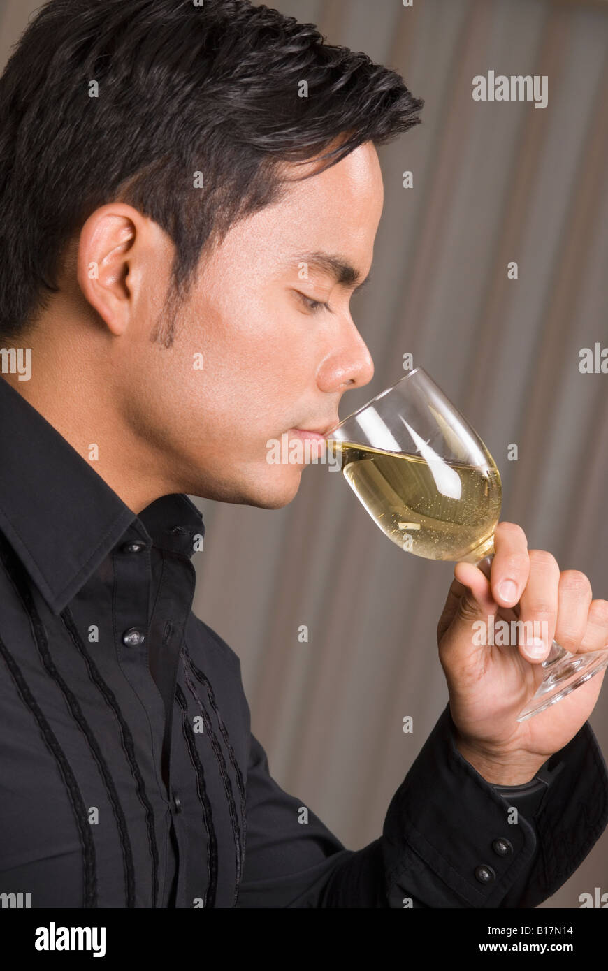Hispanic man drinking wine Stock Photo