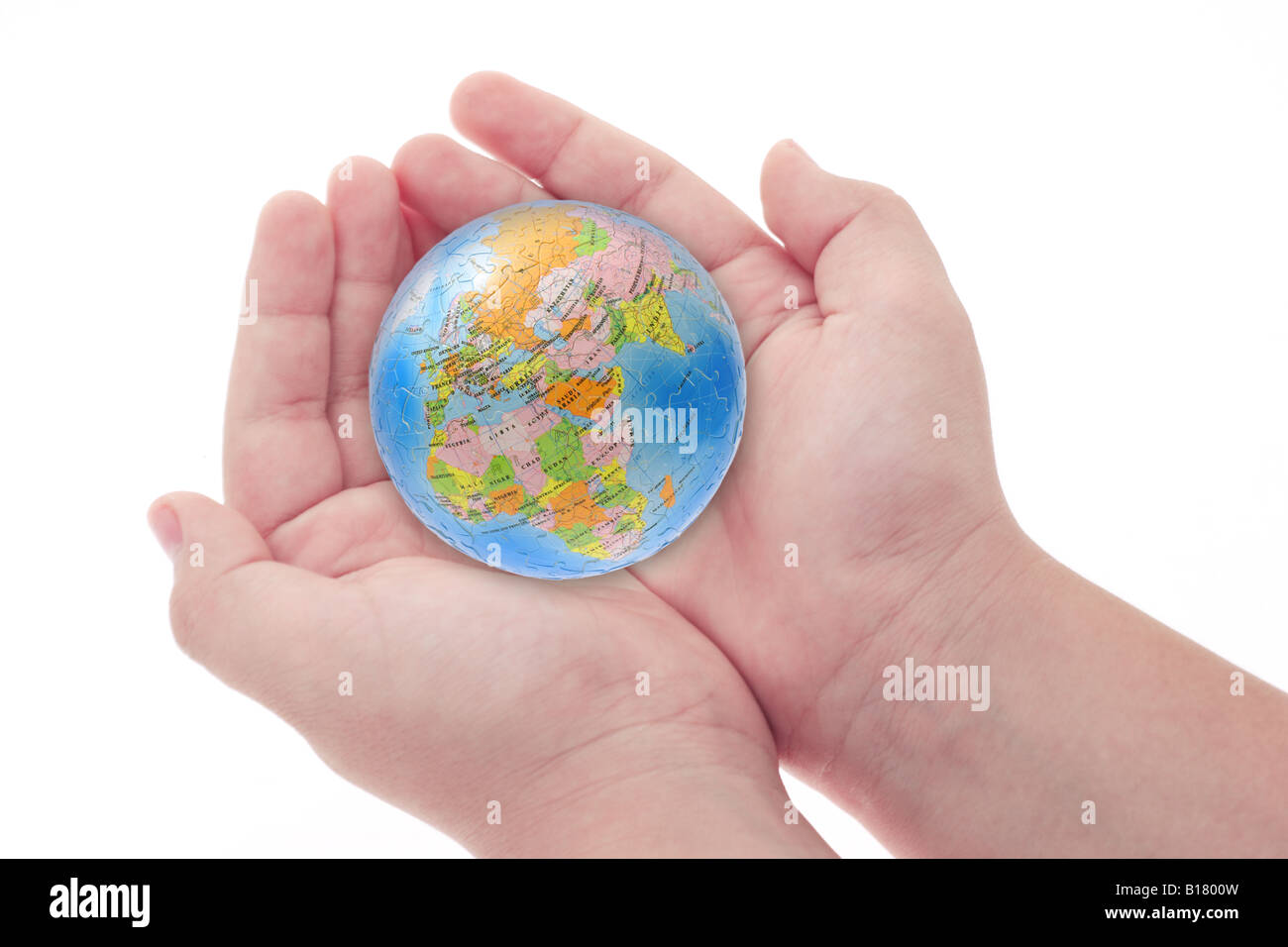 Child s hands holding Jigsaw puzzle globe on white background Stock Photo