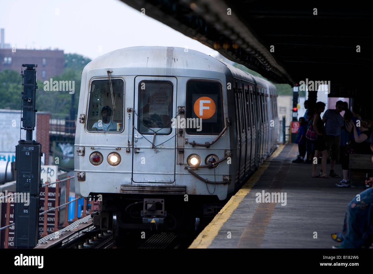 a-coney-island-bound-f-train-in-brooklyn-ny-stops-at-an-elevated-subway