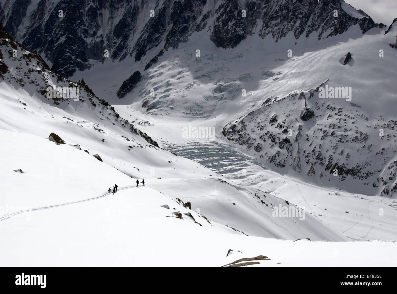 Ski tourers pausing for a rest during ascent from Argentiere Glacier towards Col du Passon, Chamonix valley, France Stock Photo