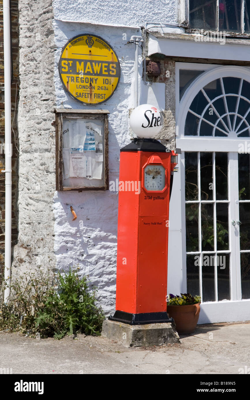 Vintage Shell petrol pump and AA mileage sign, St Mawes Harbour Cornwall England. Stock Photo