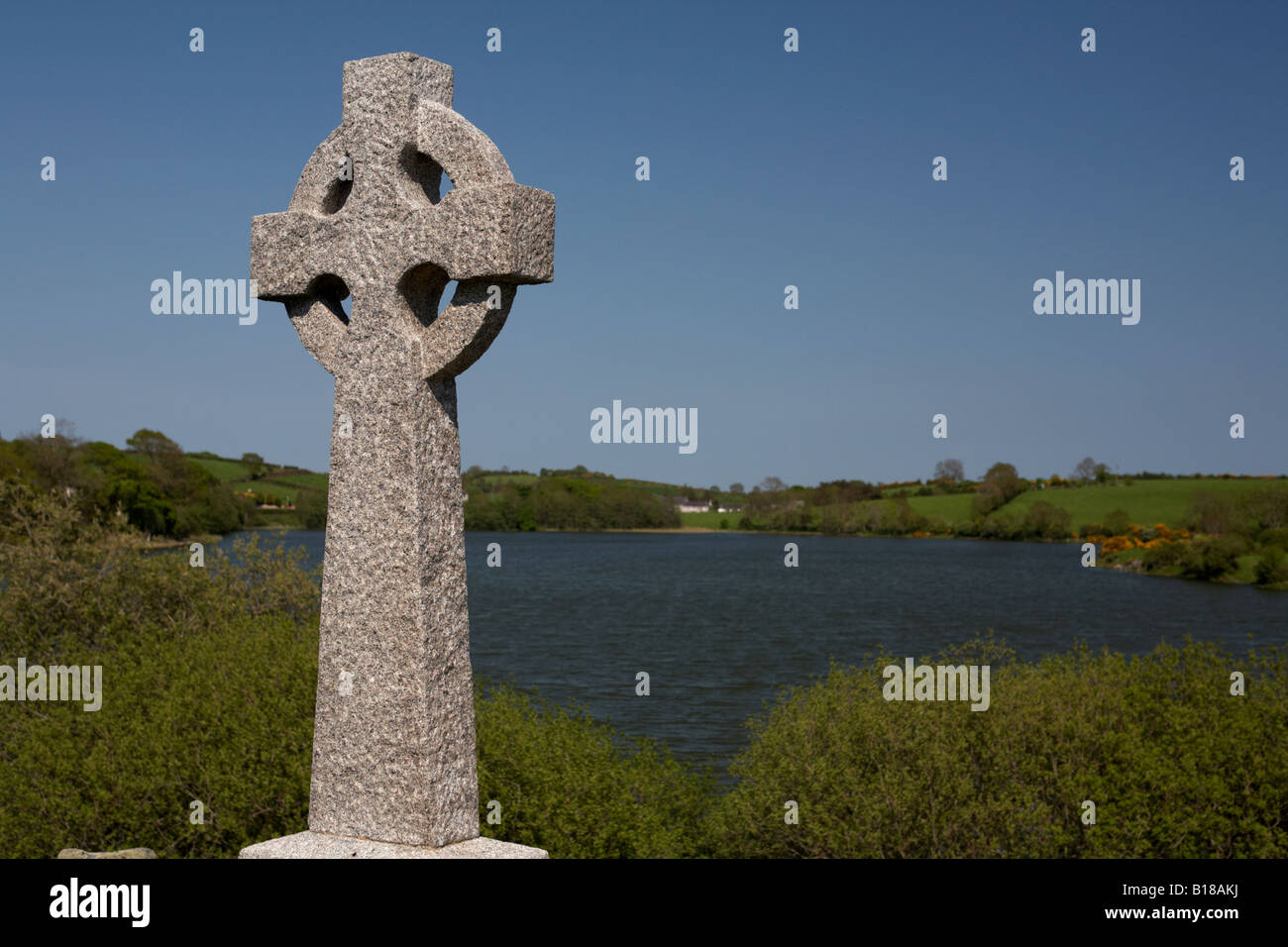 celtic cross gravestone overlooking loughinisland lake on the site of the loughinisland churches county down northern ireland Stock Photo