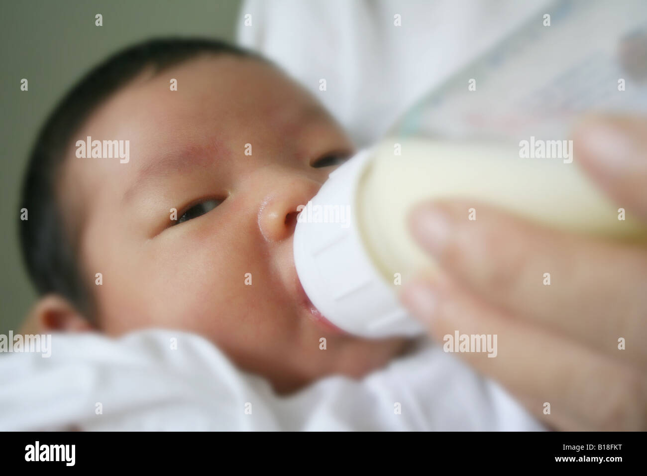 Baby drinking milk from bottle Stock Photo Alamy