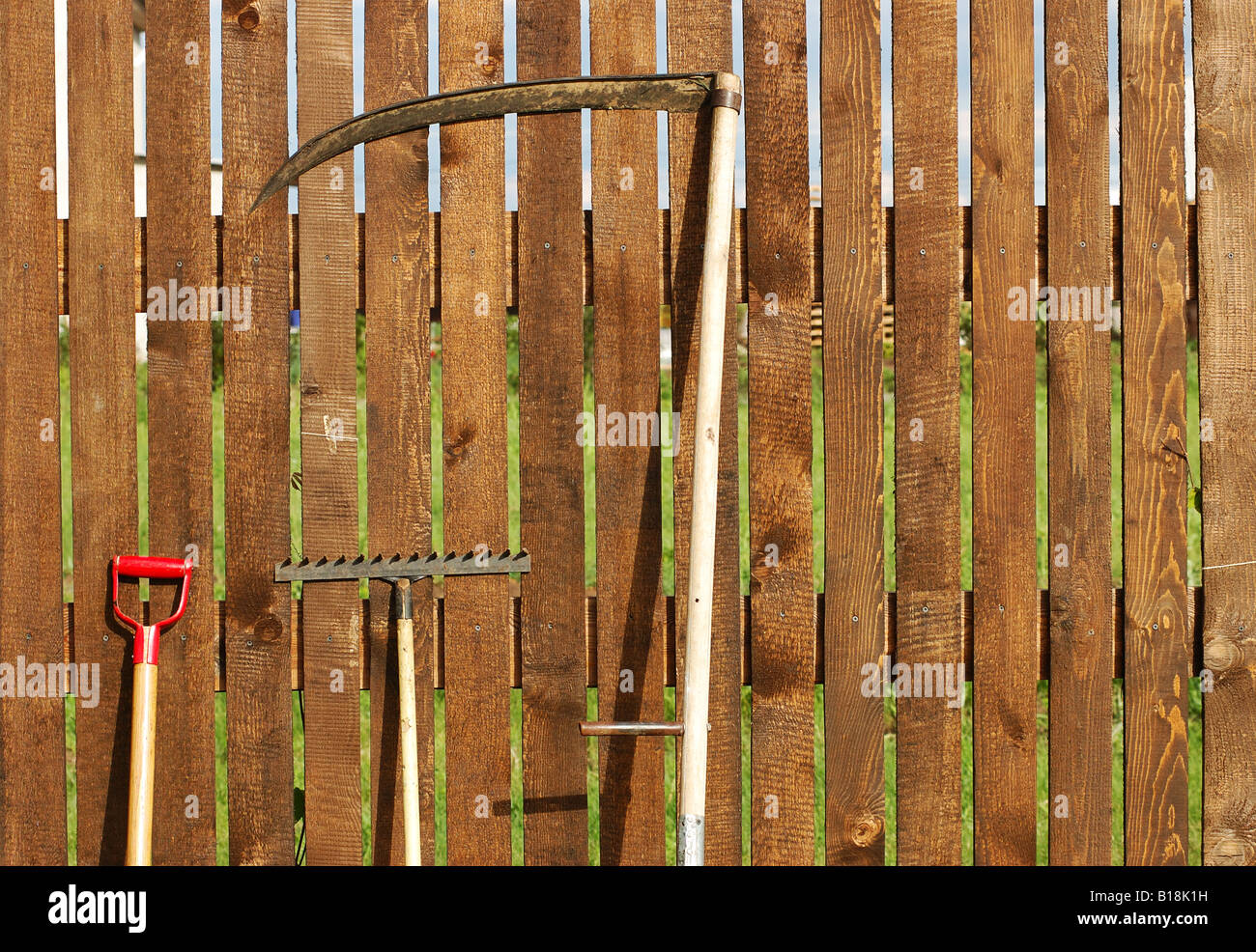 garden tool set over wood backyard fence Stock Photo Alamy