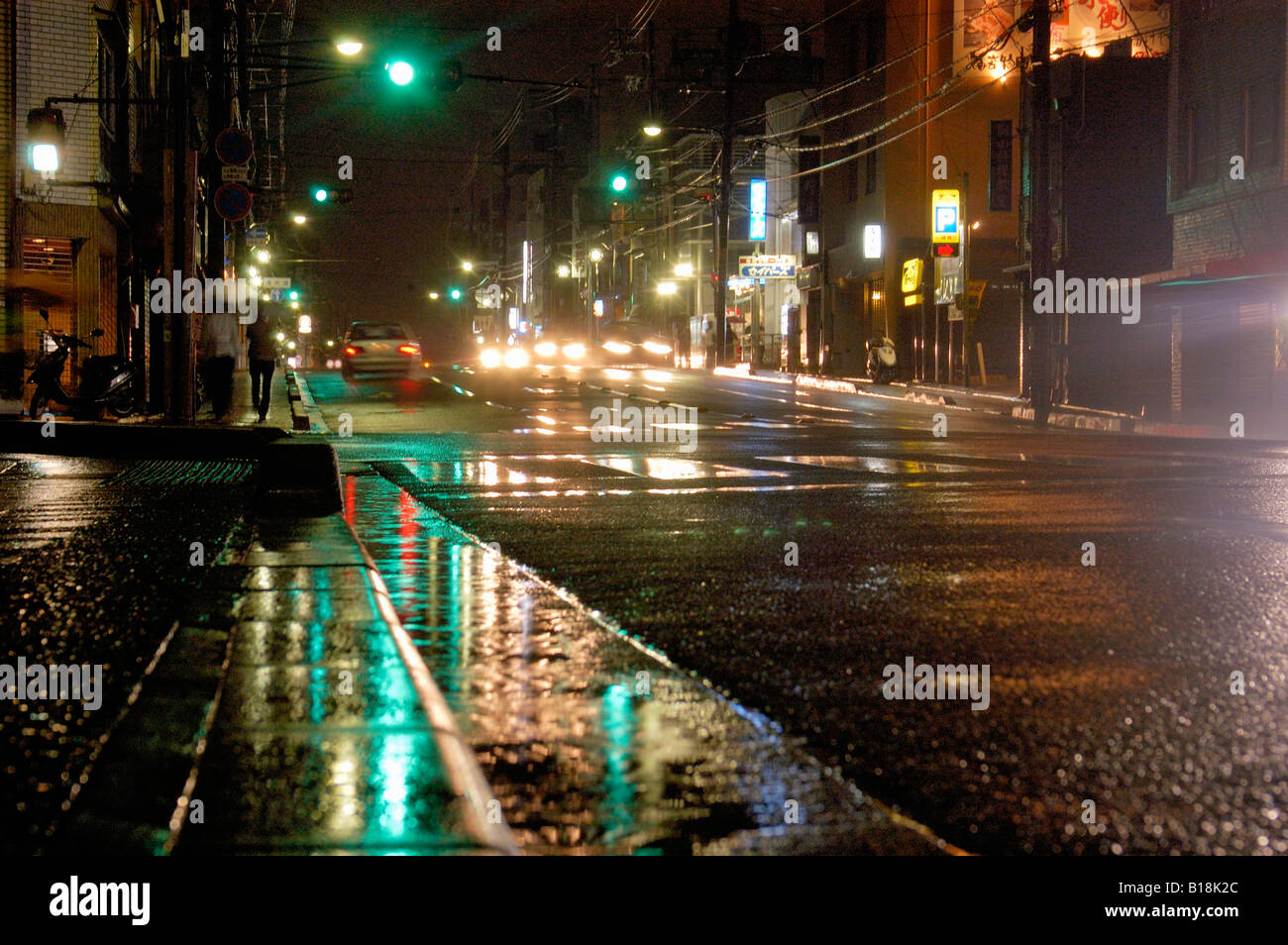 reflections in street at night Kyoto Japan Stock Photo