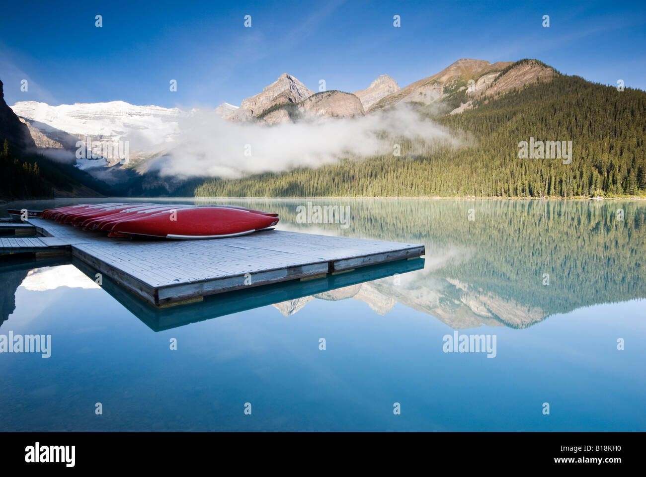 Banff Dock Canoes sit on the dock early in the morning at Lake Louise, Banff ...