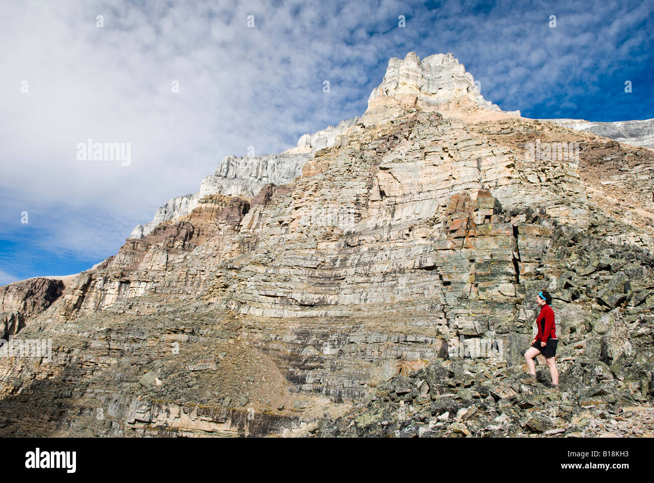 A female hiker looks out from Sentinel Pass near Moraine Lake in Banff National Park, Alberta, Canada. Stock Photo