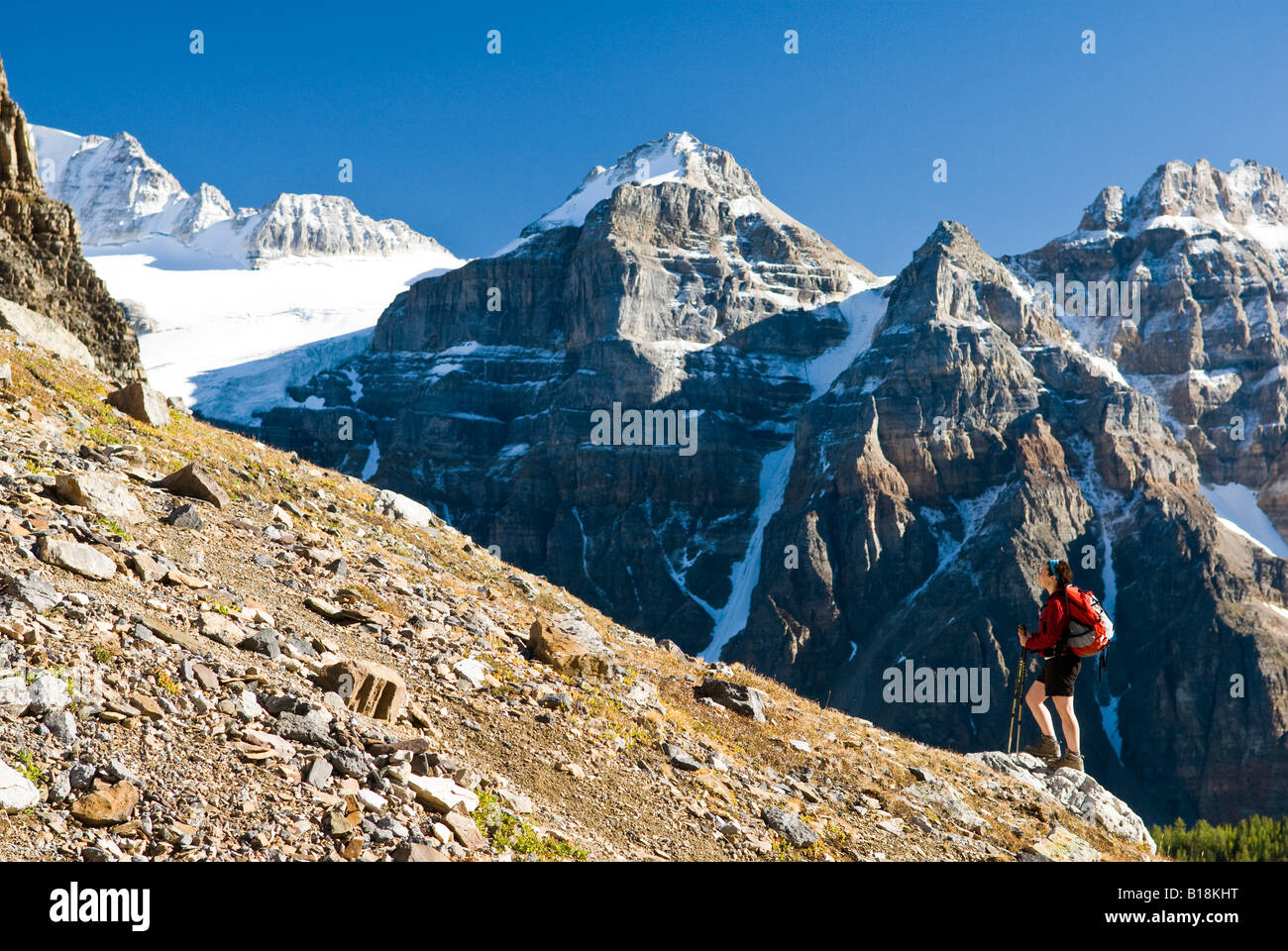 A female hiker above Moraine Lake and the Valley of the Ten Peaks en route to Sentinel Pass, Alberta, Canada. Stock Photo
