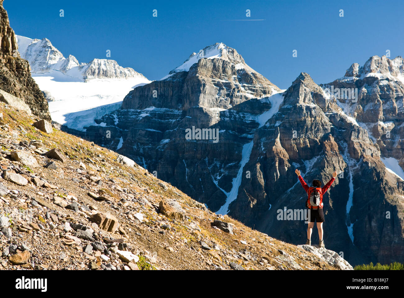 A female hiker above Moraine Lake and the Valley of the Ten Peaks en route to Sentinel Pass, Alberta, Canada. Stock Photo