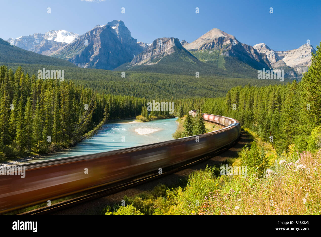 A train passes through the famous Morant's Curve near Lake Louise in Banff National Park, Alberta, Canada. Stock Photo
