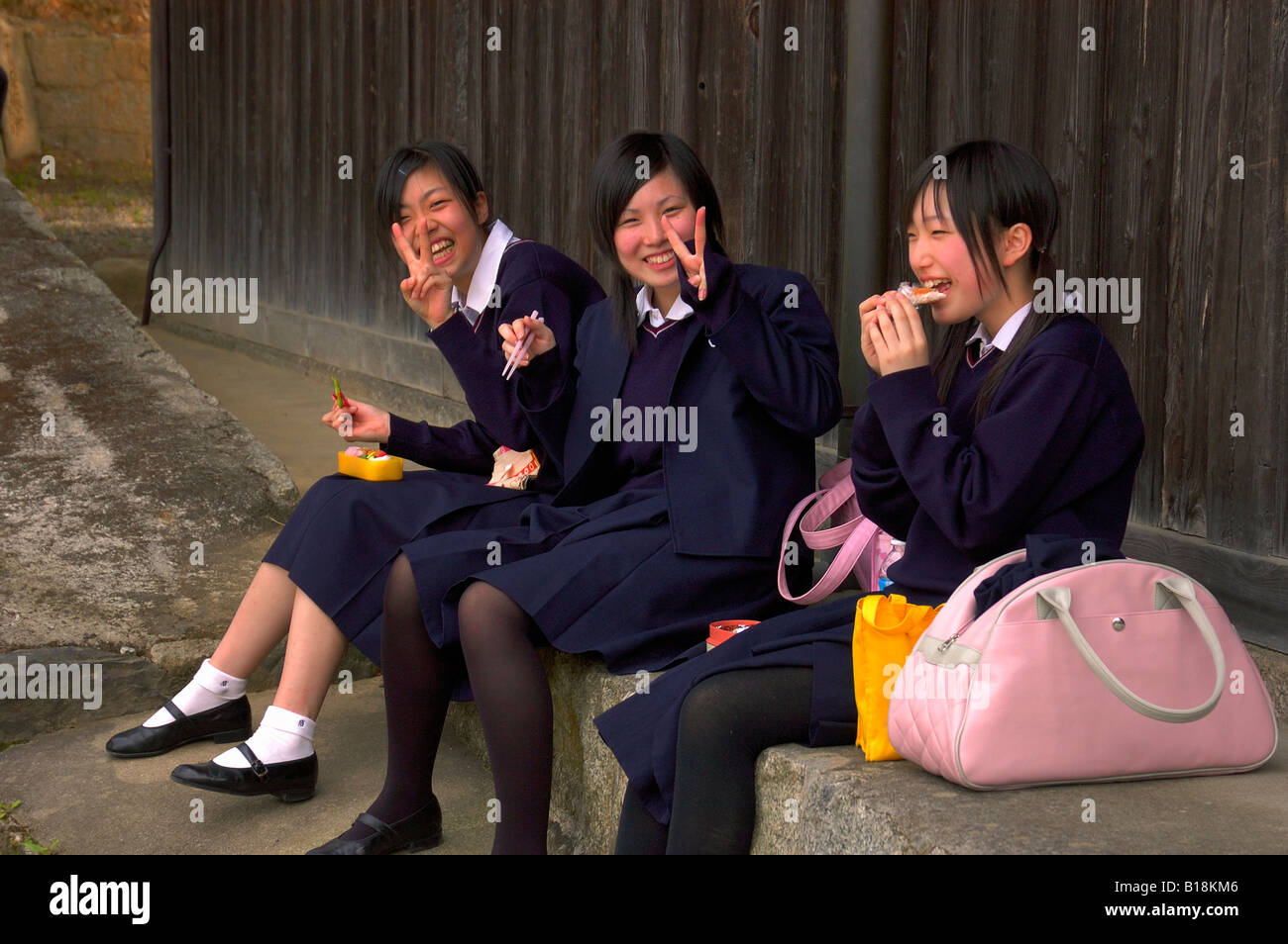 girls in uniform having lunch break Kyoto Japan Stock Photo