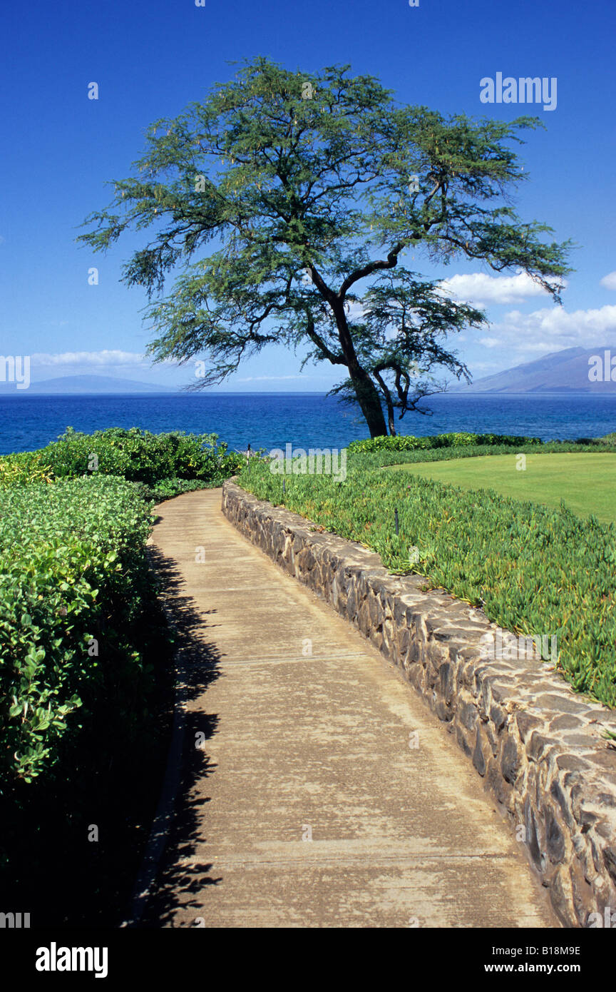 Maui, Hawaii, USA. Wailea Point, south Maui. Wailea Coastal Walkway, West Maui in the distance on right. Stock Photo
