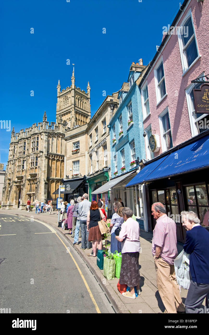 Queue at a bus stop in Market Square, Cirencester, Gloucestershire, England Stock Photo
