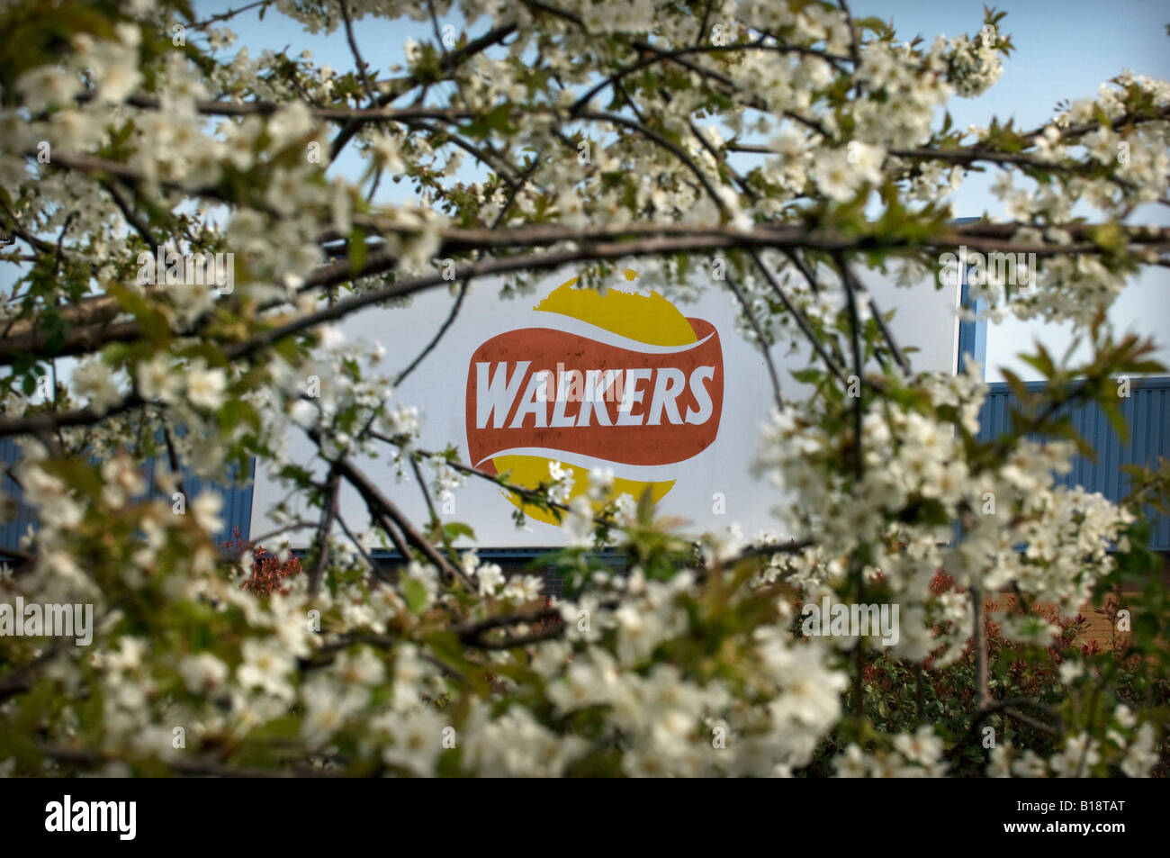 The Walkers Crisp snack food sign logo on the corporate factory and