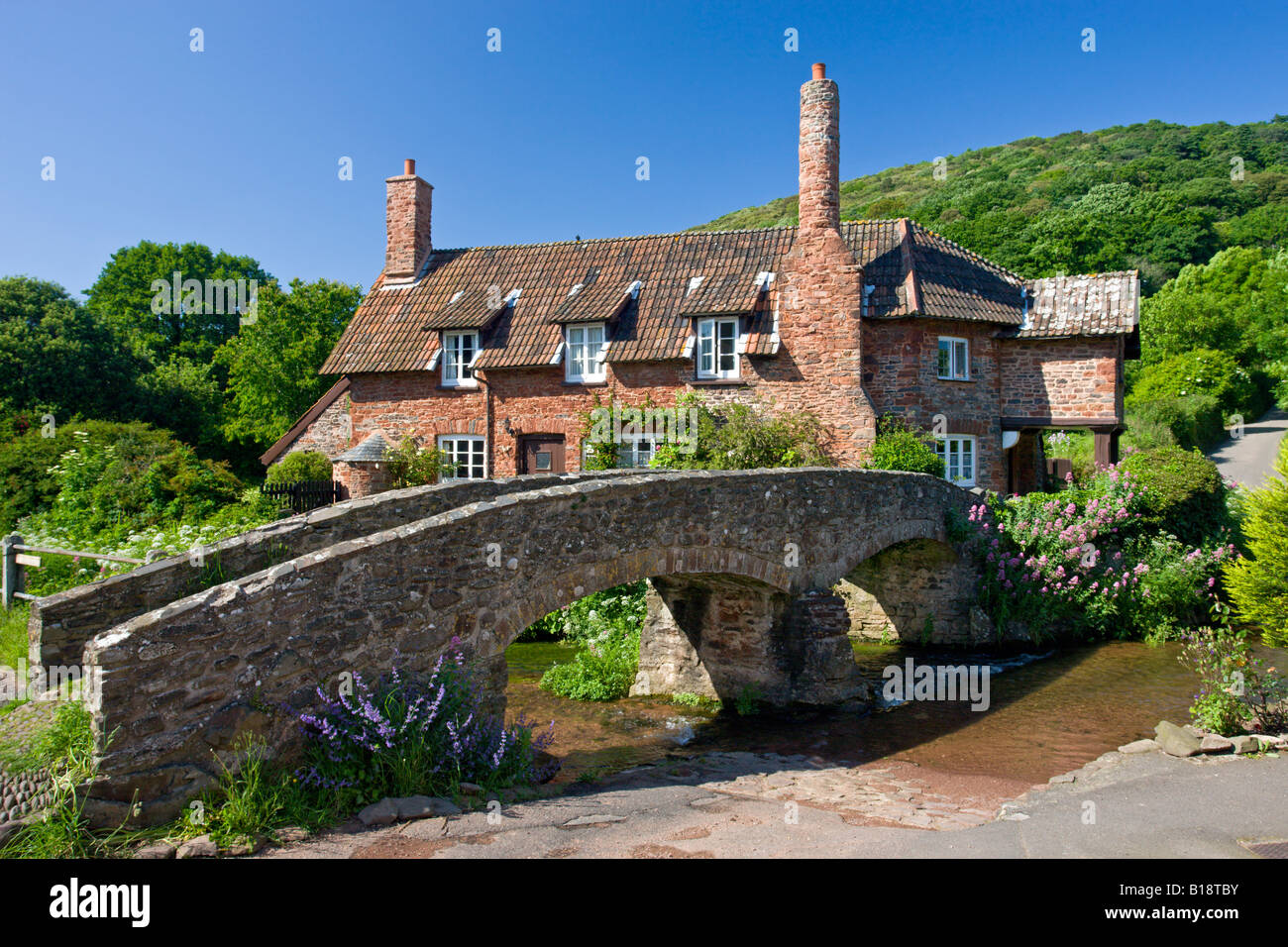 Pack Horse Bridge and cottage in the picturesque village of Allerford Exmoor National Park Somerset England Stock Photo
