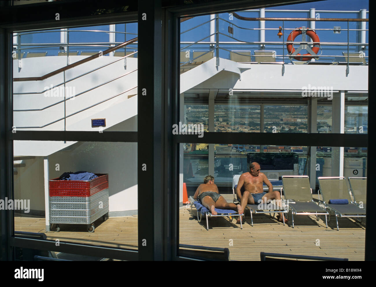 passengers on the swimming pool deck of cruise ship Stock Photo