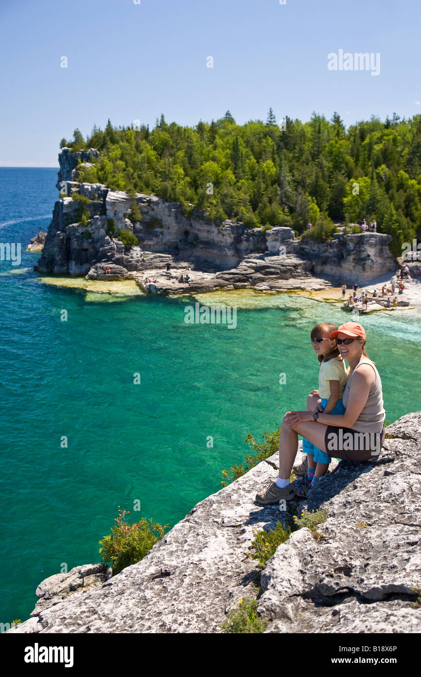 Youn woman and daughter enjoy view at Indian Head Cove along Bruce Trail, Bruce Penninsula National Park, near Tobermory, Ontari Stock Photo