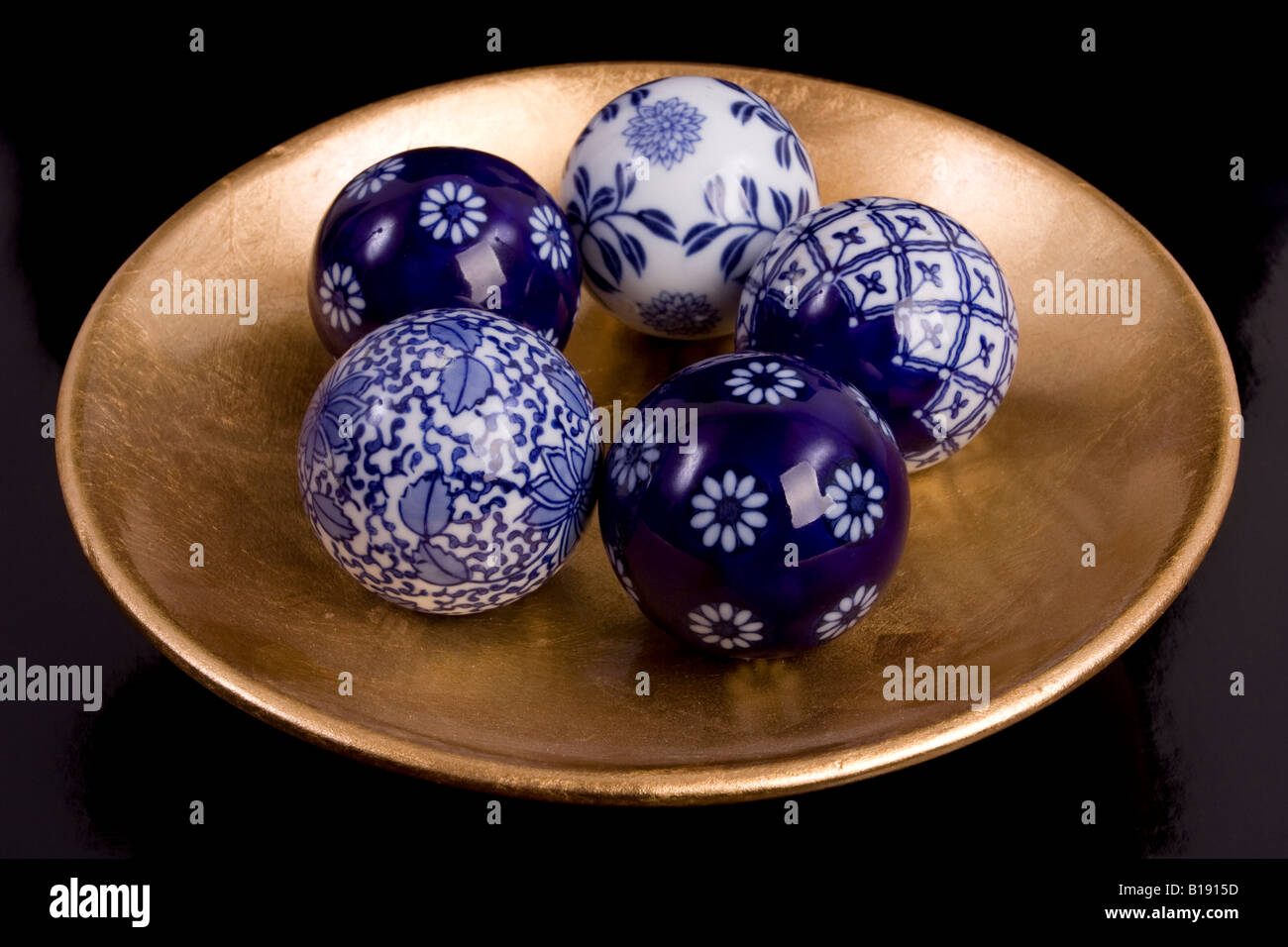 Decorative ceramic spheres on gold saucer Stock Photo Alamy
